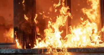 firefighter-hero-carrying-baby-girl-out-from-burning-building-area-from-fire-incident-rescue-people-from-dangerous-place-team-work-high-quality-photo-scaled